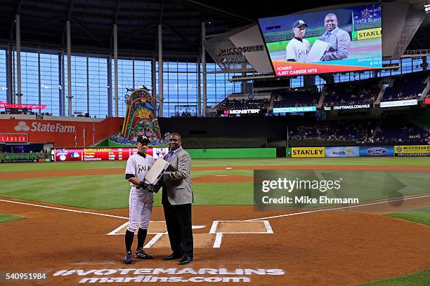 Ichiro Suzuki of the Miami Marlins is presented with the base celebrating his 4,257th hit between Japan and MLB during a game against the Colorado...