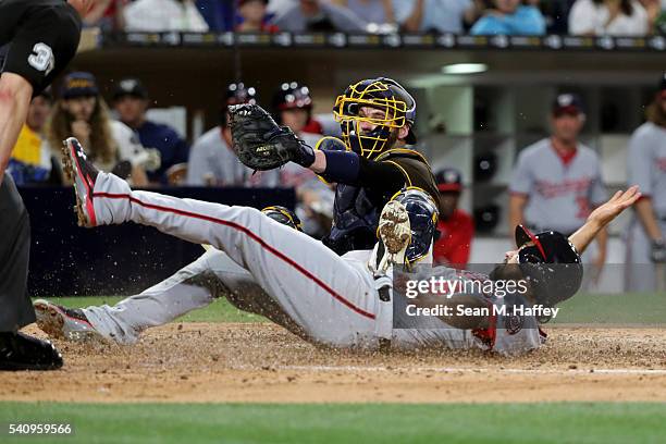 Derek Norris of the San Diego Padres tags out Anthony Rendon of the Washington Nationals at home during the sixth inning of a baseball game at PETCO...