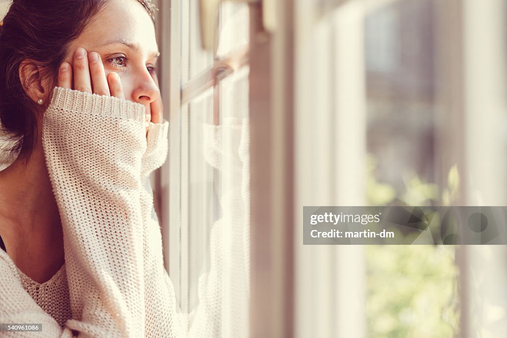 Girl looking through the window