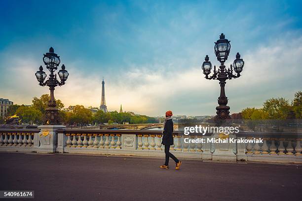 woman on a bridge in paris - paris street woman stock pictures, royalty-free photos & images