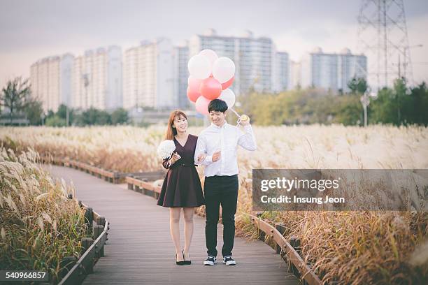 Young couple standing in silver grass field