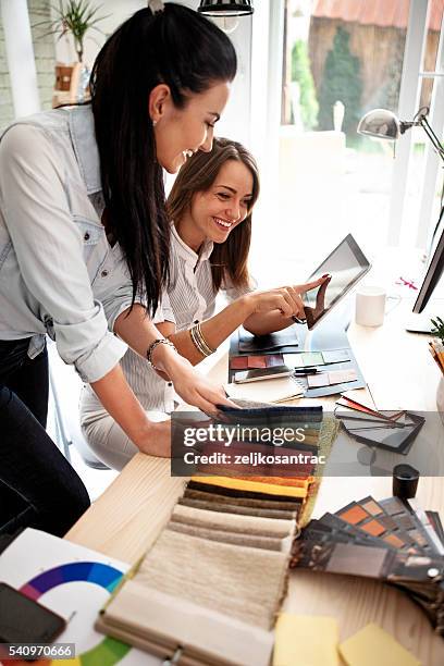 businesswoman using a digital tablet in an office - interior designer stock pictures, royalty-free photos & images