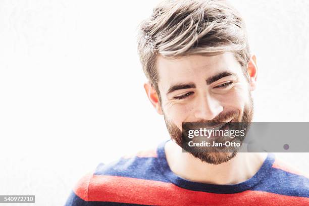 portrait of young smart french guy at window - man eyebrows stock pictures, royalty-free photos & images
