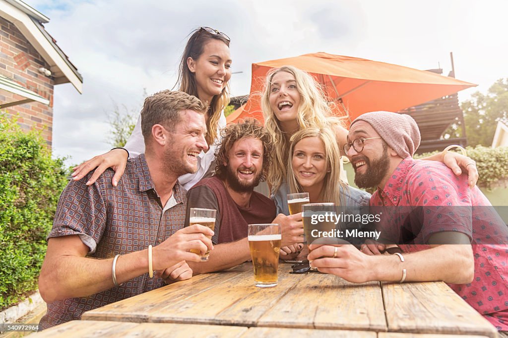 Friends celebrating with some beers at summer party