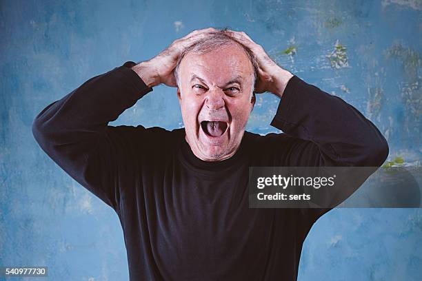 portrait of screaming senior man - hands behind head stock pictures, royalty-free photos & images