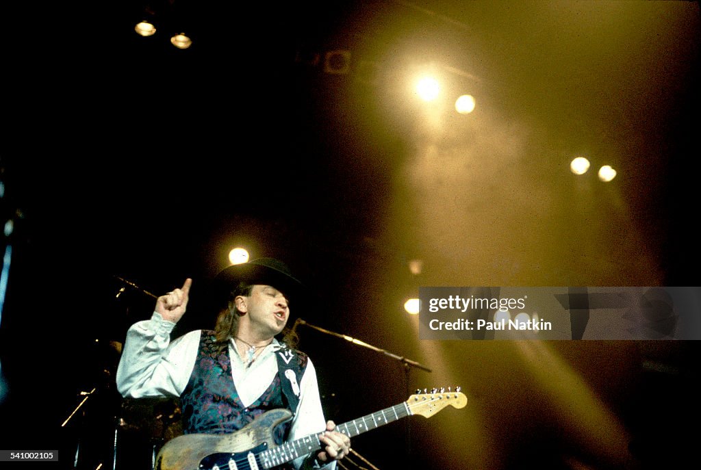 American musician Stevie Ray Vaughan plays guitar as he performs ...