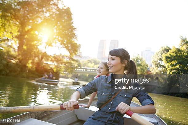 mother and daughter rowing boat - central park manhattan stock pictures, royalty-free photos & images