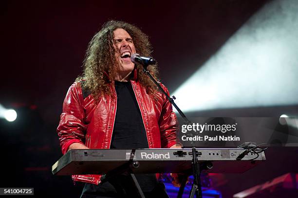 American musician and comedian Weird Al Yankovic, in costume plays keyboards as he performs onstage at the Star Plaza Theater, Merrillville, Indiana,...