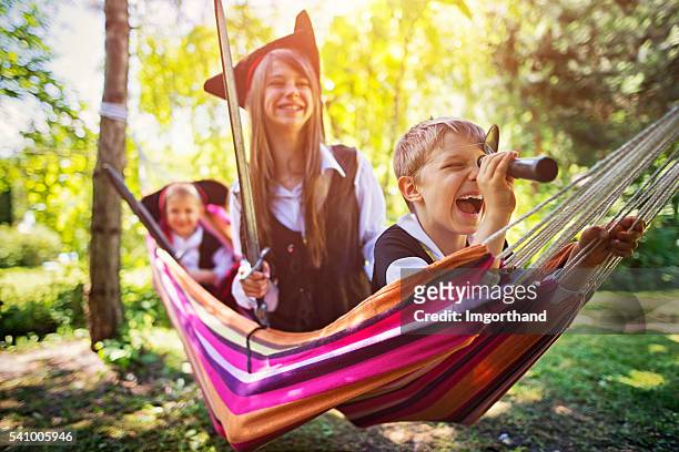 kids playing pirates on hammock boat - period costume stock pictures, royalty-free photos & images