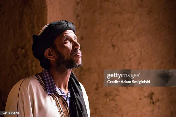 man in white dress posing in kasbah - north africa stock pictures, royalty-free photos & images