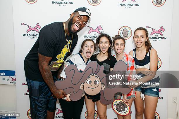 Martellus Bennett poses with attendees during the Hey AJ Imagination Lounge Pop Up on June 17, 2016 in Boston, Massachusetts.