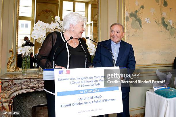 Line Renaud hands the Insignia of "Commandeur de l'Ordre National du Merite" to Levon Sayan at Hotel d'Evreux on June 14, 2016 in Paris, France.