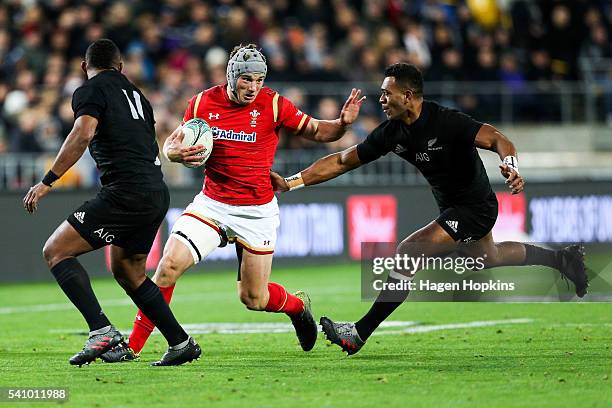 Jonathan Davies of Wales is tackled by Waisake Naholo and Seta Tamanivalu of the All Blacks during the International Test match between the New...