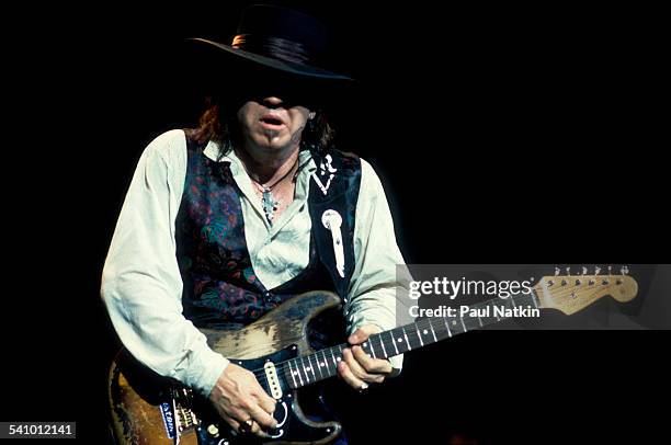 American musician Stevie Ray Vaughan plays guitar as he performs onstage at the Alpine Valley Music Theater, East Troy, Wisconsin, August 25, 1990.