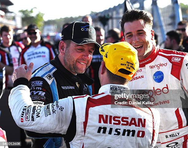 Michael Caruso driver of the Nissan Motorsport Nissan Altima race winner is congratulated by Todd Kelly driver of the Carsales Racing Nissan Altima...