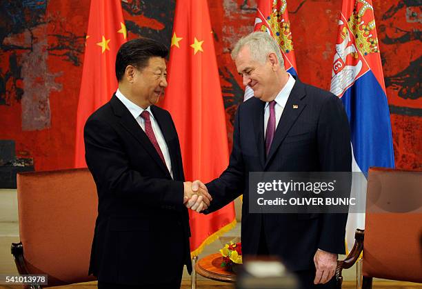 Chinese President Xi Jinping shakes hands with Serbian President Tomislav Nikolic during a meeting at the Palace of Serbia in Belgrade on June 18,...