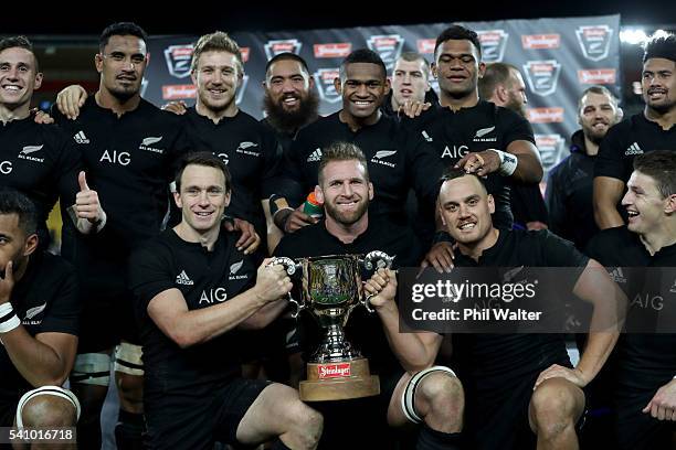 All Blacks captain Kieran Read holds the trophy with Ben Smith and Israel Dagg following the International Test match between the New Zealand All...