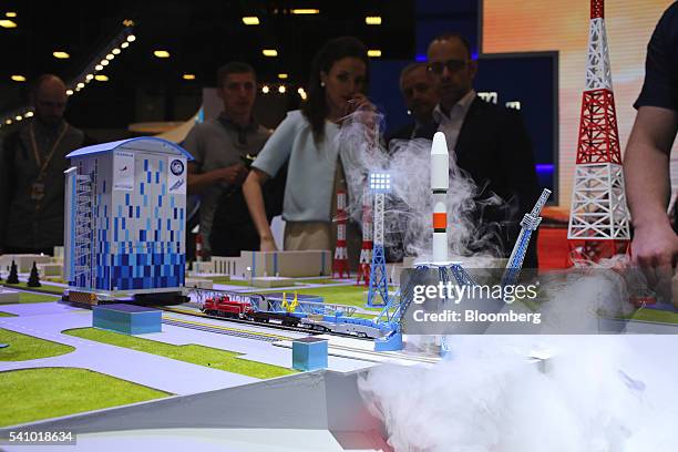 Attendees watch a model demonstration of the Vostochny Cosmodrome, a proposed new Russian space center development, on the closing day of the St....