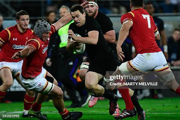 New Zealand's Ben Smith is tackled by Tyler Morgan and Sam Warburton of Wales during the rugby Test match between the New Zealand All Blacks and...