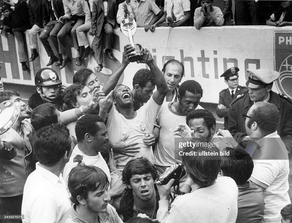 1970 FIFA World Cup in Mexico Pele (Edson Arantes do Nascimento) 1940 - Brazilian football player, 1994 Minister of Sports in Brazil - Celebrating Pele, surrounded by teammates, is raising the Jues Rimet Trophy after beating Italy in the final - June