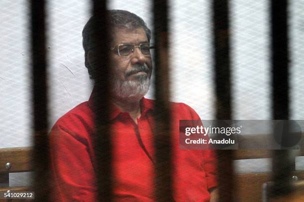 Egypts ousted President Mohamed Morsi is seen behind the bars during his trial on charges of espionage on behalf of Qatar at the Police Academy in...