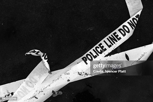 Police tape is discarded on the ground near the Pulse nightclub in downtown Orlando on June 17, 2016 in Orlando, Florida. Following a week of...