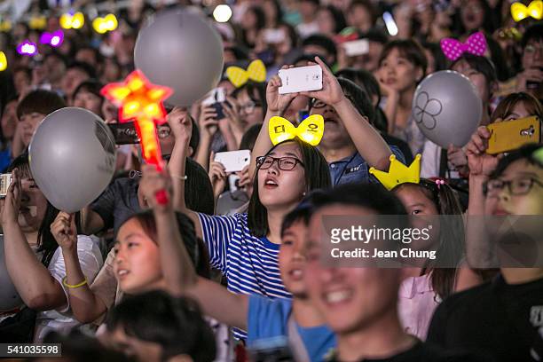 South Korean K-Pop fans cheer as a K-Pop band perform on stage on June 18, 2016 in Suwon, South Korea.The particular concert was organized by the...