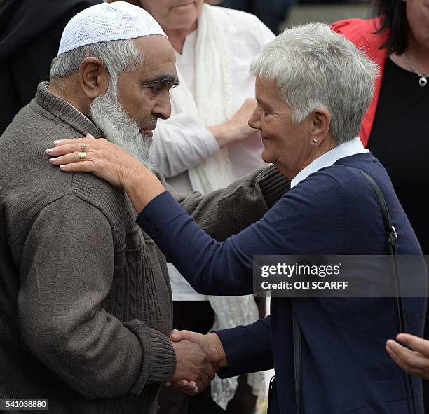 Jean Leadbeater , the mother of murdered Labour MP Jo Cox, greets Gulham Maniyar the father of Jo Cox's assistant at the heaped floral tributes to Jo...