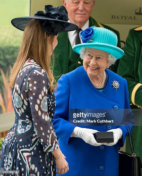 Princess Beatrice presents Queen Elizabeth II with the first prize for winning The Hardwick Stakes with her horse Dartmouth on day 5 of Royal Ascot...