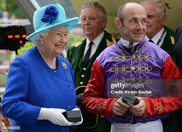 Queen Elizabeth II and Olivier Peslier celebrate their prizes after winning the Hardwicke Stakes on day 5 of Royal Ascot at Ascot Racecourse on June...