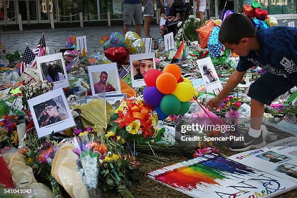 People visit a memorial down the road from the Pulse nightclub on June 18, 2016 in Orlando, Florida. In what is being called the worst mass shooting...