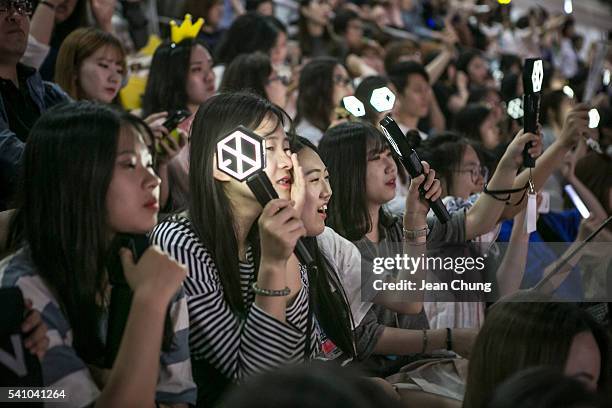 South Korean K-Pop fans, mostly of a boy band called Exo, cheer as a K-Pop band perform on stage on June 18, 2016 in Suwon, South Korea.The...