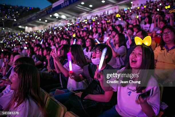 South Korean K-Pop fans, mostly of a boy band called Exo, cheer as a K-Pop band perform on stage on June 18, 2016 in Suwon, South Korea.The...