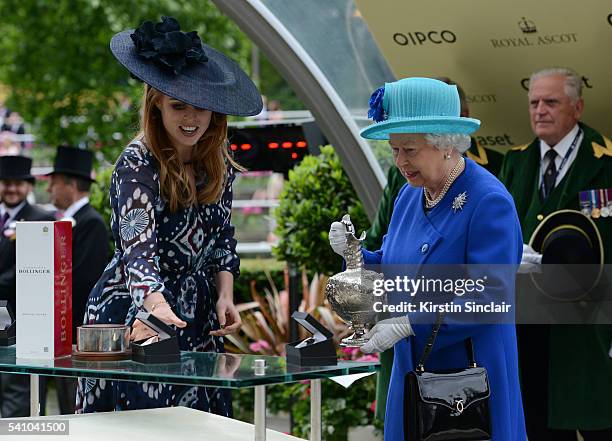 Princess Beatrice presents Queen Elizabeth II with her prize after Dartmouth won the Hardwicke Stakes on day 5 of Royal Ascot at Ascot Racecourse on...