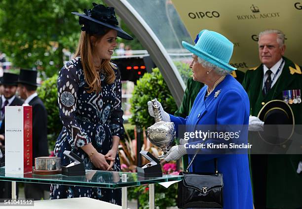 Princess Beatrice presents Queen Elizabeth II with her prize after Dartmouth won the Hardwicke Stakes on day 5 of Royal Ascot at Ascot Racecourse on...