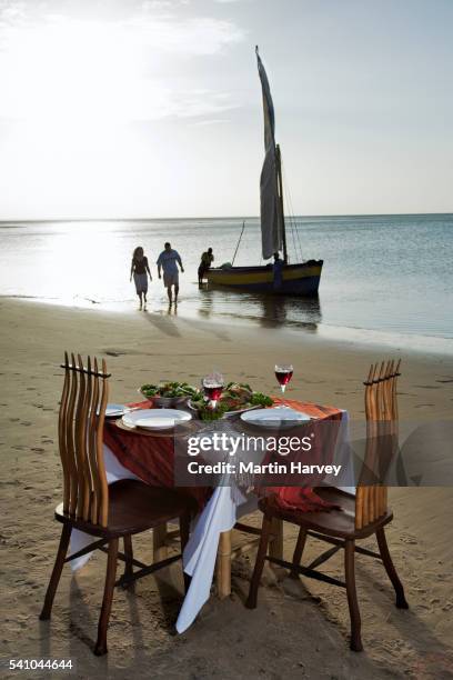 romantic dinner on beach at benguerra lodge - mozambique beach stock pictures, royalty-free photos & images