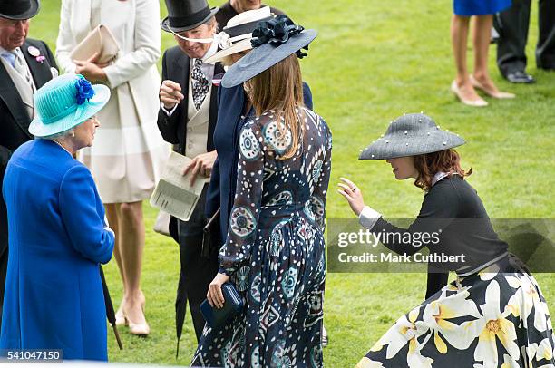 Princess Beatrice with Princess Eugenie who is doing a curtsey to Queen Elizabeth II on day 5 of Royal Ascot at Ascot Racecourse on June 18, 2016 in...