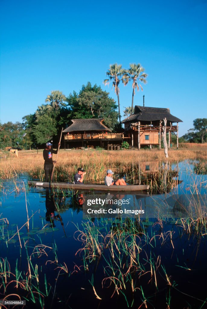Botswana Men Punting Tourists Though Okavango Delta