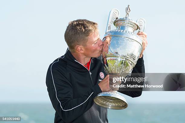 Scott Gregory of Corhampton, winner of the Amateur Championship 2016, kisses the cup after beating opponent Robert MacIntyre of Glencruitten on the...