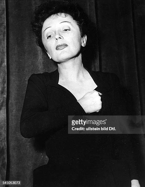 Born Edith Giovanna Gassion. French singer and actress. Photographed in 1956.