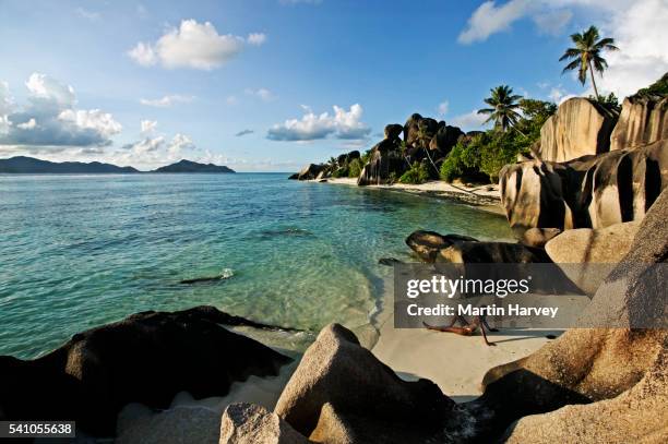 woman alone on small beach - seychelles stock pictures, royalty-free photos & images