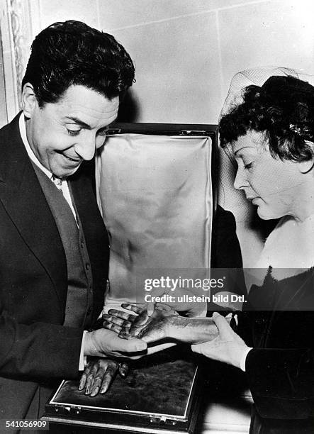 Edith Piaf*19.12..1963+Cabaret singer, Francereceives a gift from her husband Jacques Pills on the first anniversary of their wedding