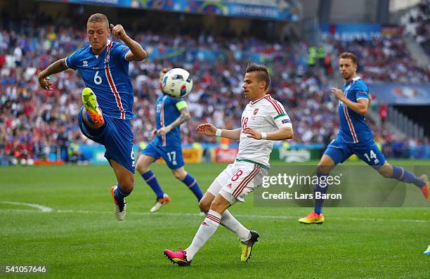 Ragnar Sigurdsson of Iceland and Adam Nagy of Hungary compete for the ball during the UEFA EURO 2016 Group F match between Iceland and Hungary at...