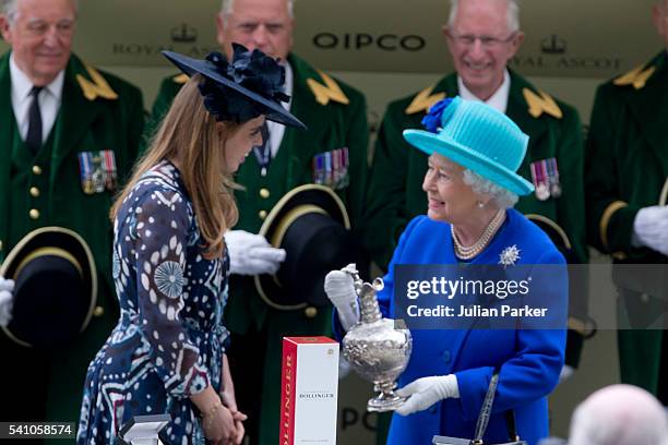 Princess Beatrice presents Queen Elizabeth II with the trophy, after her horse Dartmouth won The Hardwick Stakes, on day 5 of Royal Ascot at Ascot...