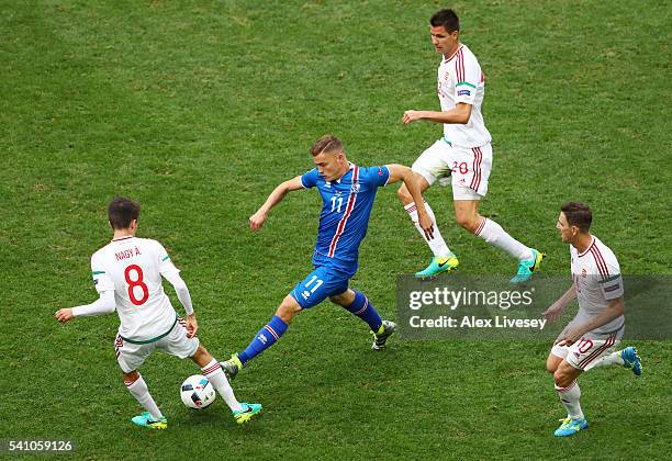 Alfred Finnbogason of Iceland takes the ball past Adam Nagy of Hungary during the UEFA EURO 2016 Group F match between Iceland and Hungary at Stade...