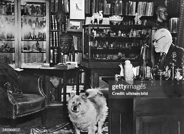 Austrian author and founder of psychoanalysis Sigmund Freud with his chow, Jofi, in his study at Berggasse 19, Vienna, Austria, circa 1937. The photo...