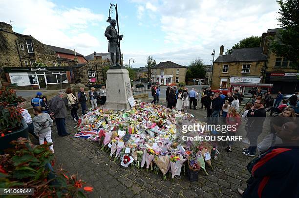 Members of the public view the floral tributes left to murdered Labour MP Jo Cox at the statue to Joseph Priestley near to the location where she was...