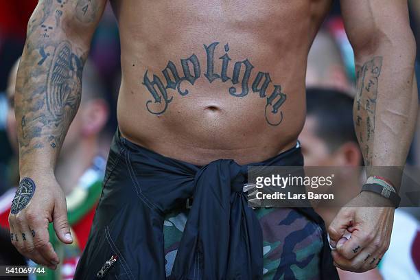 A Hungary supporter shows off a tattoo on his torso reading 'Hooligan' during the UEFA EURO 2016 Group F match between Iceland and Hungary at Stade...