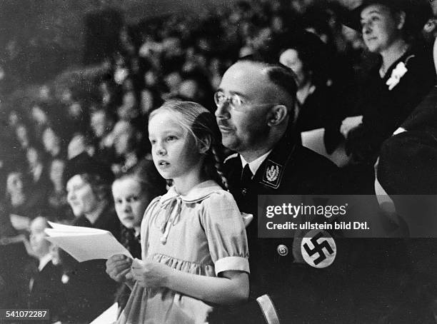 German Reichsf³hrer-SS and Gestapo chief. Himmler and his daughter at a sports event at Berlin, Germany, March 1938.