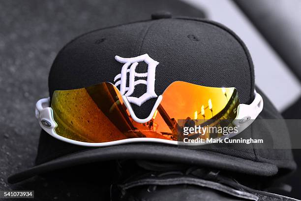 Detailed view of a pair of Oakley sunglasses sitting on a Detroit Tigers baseball hat in the dugout during the game against the Chicago White Sox at...